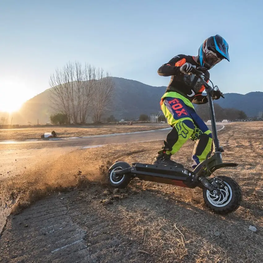 Guy with helmet riding scooter offroad